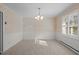 Dining room with wallpaper, a chandelier, and natural light from shuttered windows at 3001 Blanche Dr, Burlington, NC 27215
