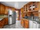 Kitchen with stainless steel appliances, light wood cabinets, and stone countertops at 3001 Blanche Dr, Burlington, NC 27215