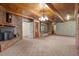 Carpeted living room featuring brick fireplace, wood paneled ceiling, and wood trim at 3001 Blanche Dr, Burlington, NC 27215
