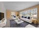 Bright living room with white furniture, large windows, and view to dining room at 3001 Blanche Dr, Burlington, NC 27215