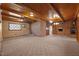 Large living room with carpeted floor, brick walls, and wood paneled ceilings at 3001 Blanche Dr, Burlington, NC 27215