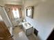Bathroom featuring a vanity, toilet, bathtub with shower curtain, and window with curtains at 3015 Nc Hwy 87 South, Graham, NC 27253