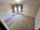 Bright bedroom features natural light and a neutral color palette, ideal for personalization at 3015 Nc Hwy 87 South, Graham, NC 27253