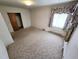 Bedroom with closet and window has neutral walls, carpet, offering ample space at 3015 Nc Hwy 87 South, Graham, NC 27253