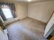 Bright bedroom featuring a window with curtains and carpet offers ample space at 3015 Nc Hwy 87 South, Graham, NC 27253
