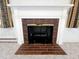 Close-up shot of a brick fireplace with a white mantel and decorative curtains on either side at 3015 Nc Hwy 87 South, Graham, NC 27253