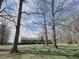 Exterior view of home on large lot with mature trees, red brick exterior, and a brick chimney at 3015 Nc Hwy 87 South, Graham, NC 27253