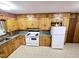 Cozy kitchen with knotty pine cabinets and functional white appliances at 3015 Nc Hwy 87 South, Graham, NC 27253