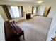 Spacious living room featuring a fireplace, carpeted floor, and natural light from the windows at 3015 Nc Hwy 87 South, Graham, NC 27253