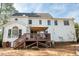 Inviting backyard featuring a spacious deck, sunroom, and well-maintained lawn, perfect for relaxation at 307 Kellyridge Dr, Apex, NC 27502