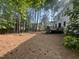 Expansive backyard with mature trees, lawn space, and a deck, creating a private retreat at 307 Kellyridge Dr, Apex, NC 27502