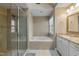 Bright bathroom featuring a shower, soaking tub, and double vanity with granite countertops at 307 Kellyridge Dr, Apex, NC 27502