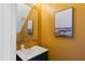 Chic powder room boasts modern fixtures and bright paint at 307 Kellyridge Dr, Apex, NC 27502