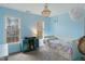 Bedroom with light blue walls, hardwood floors, and a custom chandelier and bookcase at 307 Kellyridge Dr, Apex, NC 27502