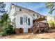 Charming home exterior with sunroom, deck, and a well-maintained lawn, perfect for outdoor enjoyment at 307 Kellyridge Dr, Apex, NC 27502