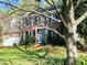 Beautiful two-story brick home with a blue front door, black shutters, and a well-manicured lawn at 307 Kellyridge Dr, Apex, NC 27502