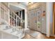 Inviting foyer with a staircase, light hardwood floors, and a glass-paneled front door letting in natural light at 307 Kellyridge Dr, Apex, NC 27502