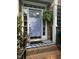 Charming brick home entrance featuring a welcoming periwinkle door with sidelights and a striped welcome mat at 307 Kellyridge Dr, Apex, NC 27502