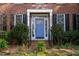 Close-up of a blue front door with sidelights, black shutters, and landscaped yard at 307 Kellyridge Dr, Apex, NC 27502