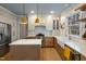 Bright kitchen with modern island, stainless steel appliances, and a farmhouse sink overlooking the backyard at 307 Kellyridge Dr, Apex, NC 27502