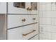 Kitchen cabinetry featuring white cabinets with bronze pulls and modern layout at 307 Kellyridge Dr, Apex, NC 27502