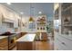Contemporary kitchen boasts stainless steel appliances, a center island, and open shelving for decor display at 307 Kellyridge Dr, Apex, NC 27502