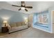 Cozy living room with neutral color scheme, plush sofa and a window reading nook at 307 Kellyridge Dr, Apex, NC 27502
