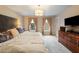 Light-filled main bedroom features a dresser and a large bed at 307 Kellyridge Dr, Apex, NC 27502