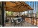 Outdoor patio dining area with metal table, chairs, grill and privacy shade at 307 Kellyridge Dr, Apex, NC 27502