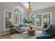 Bright sunroom with large windows, skylight, and comfortable seating at 307 Kellyridge Dr, Apex, NC 27502
