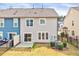 View of the rear of the home, showcasing the patio, fenced yard, and attractive landscaping at 3162 Retama Run # 231, Apex, NC 27562