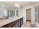 Luxurious bathroom boasts double vanity with granite countertops and glass-enclosed shower at 3162 Retama Run # 231, Apex, NC 27562