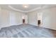 Spacious bedroom featuring plush carpeting, tray ceiling, and ensuite bathroom access at 3162 Retama Run # 231, Apex, NC 27562