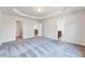 Large bedroom featuring neutral paint, gray carpet, and multiple doorways leading to other rooms at 3162 Retama Run # 231, Apex, NC 27562