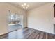 The dining room features sliding glass doors to the outside and wood-look flooring at 3162 Retama Run # 231, Apex, NC 27562
