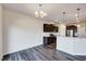 A dining area connects the kitchen with seating and modern lighting fixtures at 3162 Retama Run # 231, Apex, NC 27562