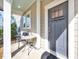 Cozy front porch with seating area and stylish front door at 3162 Retama Run # 231, Apex, NC 27562