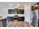 The kitchen includes stainless steel appliances, wood floors, granite countertops, and dark wood cabinets at 3162 Retama Run # 231, Apex, NC 27562