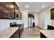 Modern kitchen with stainless steel appliances, granite countertops, and dark wood cabinets at 3162 Retama Run # 231, Apex, NC 27562