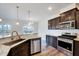 Modern kitchen with granite counters, a kitchen island, and stainless-steel appliances at 3162 Retama Run # 231, Apex, NC 27562