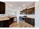 An eat-in kitchen includes stainless steel appliances, granite countertops, and dark wood cabinets at 3162 Retama Run # 231, Apex, NC 27562