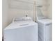 The laundry room has a washer and dryer with wire rack shelving above at 3162 Retama Run # 231, Apex, NC 27562