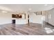 Spacious living area with wood-look floors open to kitchen, perfect for entertaining at 3162 Retama Run # 231, Apex, NC 27562