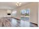 The bright living room features a fireplace, wood-look floors, and access to a covered patio at 3162 Retama Run # 231, Apex, NC 27562