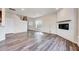 Open living room with fireplace, wood-look flooring, and lots of natural light at 3162 Retama Run # 231, Apex, NC 27562