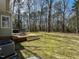 Backyard featuring a wooden deck, a grill, mature trees, and a spacious lawn at 3313 Ventura Cir, Wake Forest, NC 27587