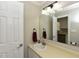 Cozy bathroom with a white vanity, sink, and a mirror reflecting a glimpse of the kitchen at 3313 Ventura Cir, Wake Forest, NC 27587