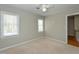 Cozy bedroom with neutral carpet, a ceiling fan and natural light from two windows at 3313 Ventura Cir, Wake Forest, NC 27587