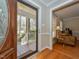 Welcoming entryway reveals hardwood floors, adjacent living area and covered front porch at 3313 Ventura Cir, Wake Forest, NC 27587