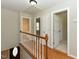 Bright upstairs hallway leading to various rooms, with hardwood floors and white trim at 3313 Ventura Cir, Wake Forest, NC 27587